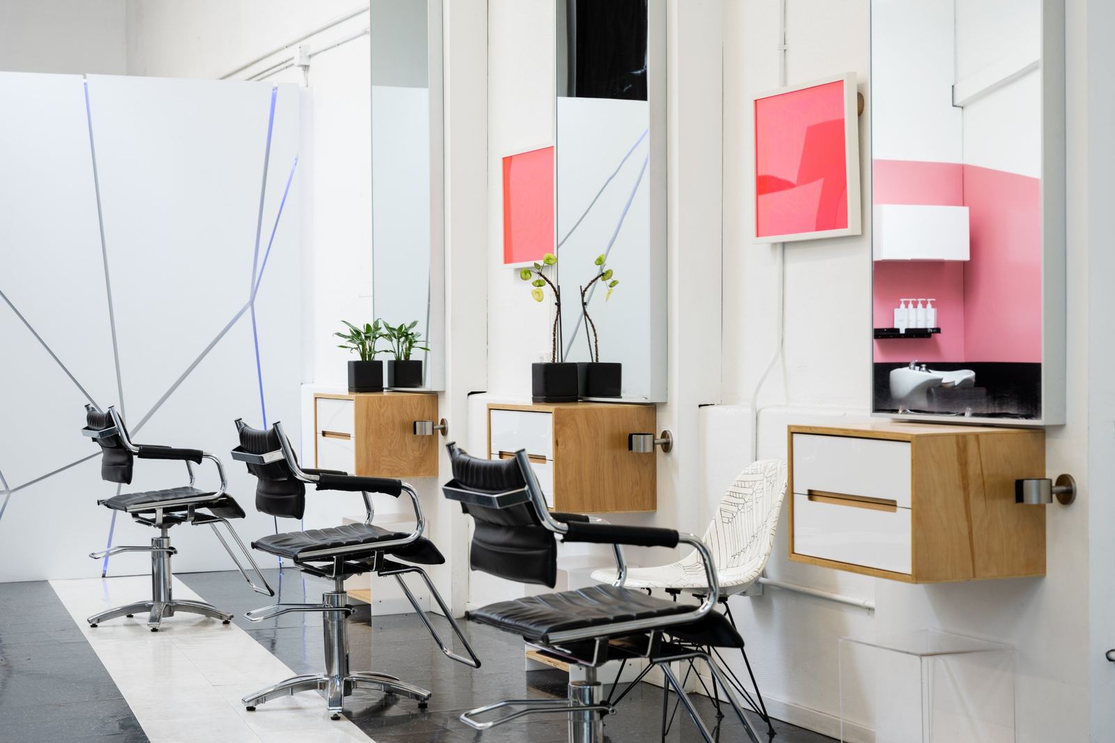 Styling chairs facing mirrors with pink framed art