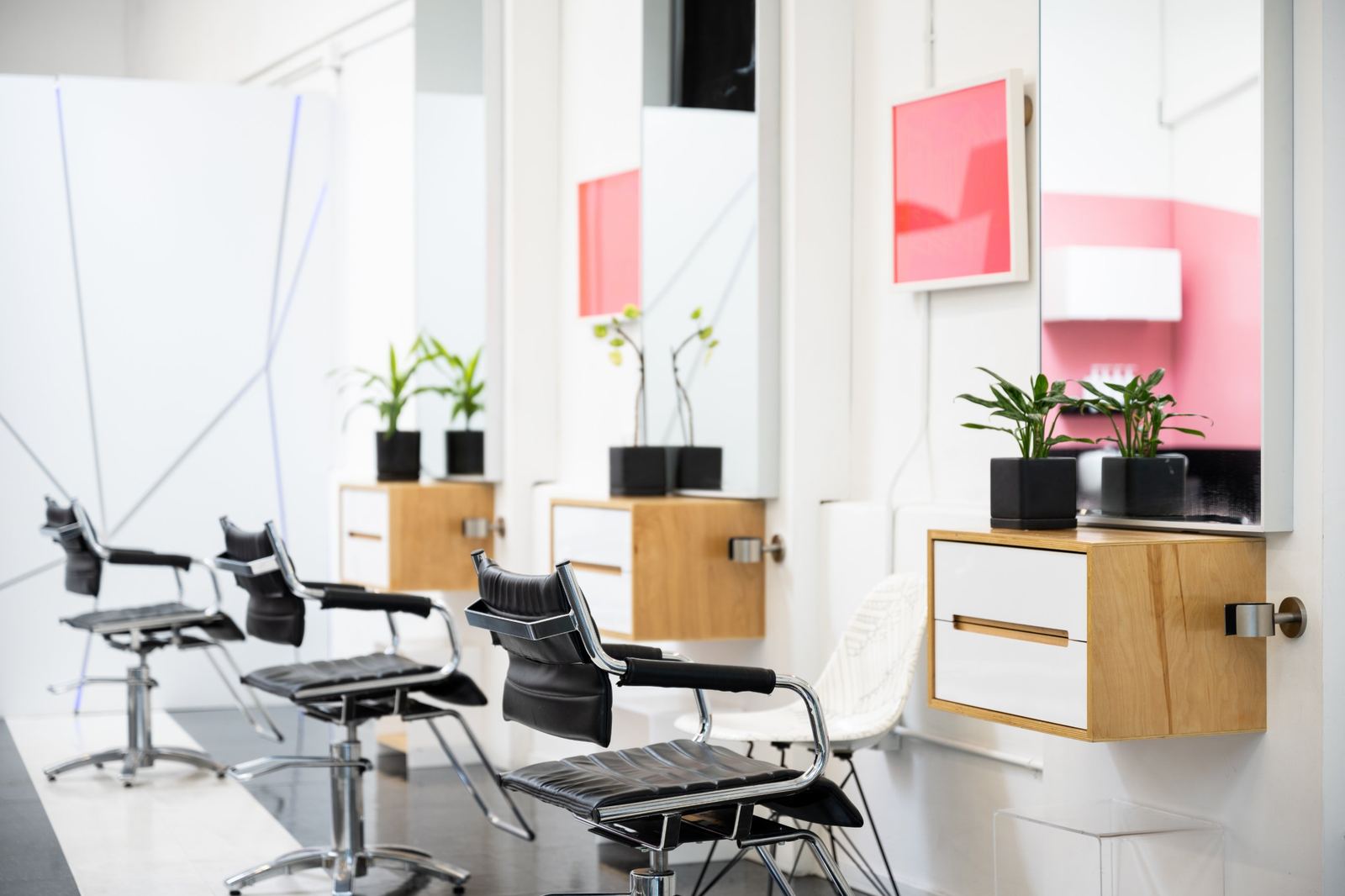 Styling chairs and mirrors with potted plants on wood cabinets
